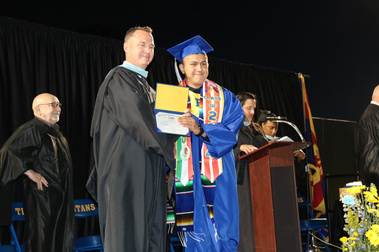 A Palo Verde grad receives his diploma from the principal