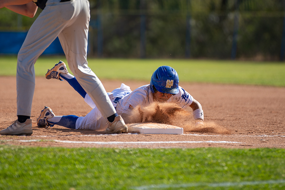 A Titan baseball player slides into home base