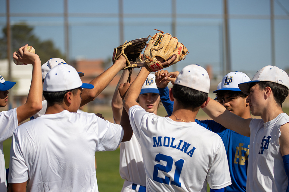 Titan baseball players huddle together after the game