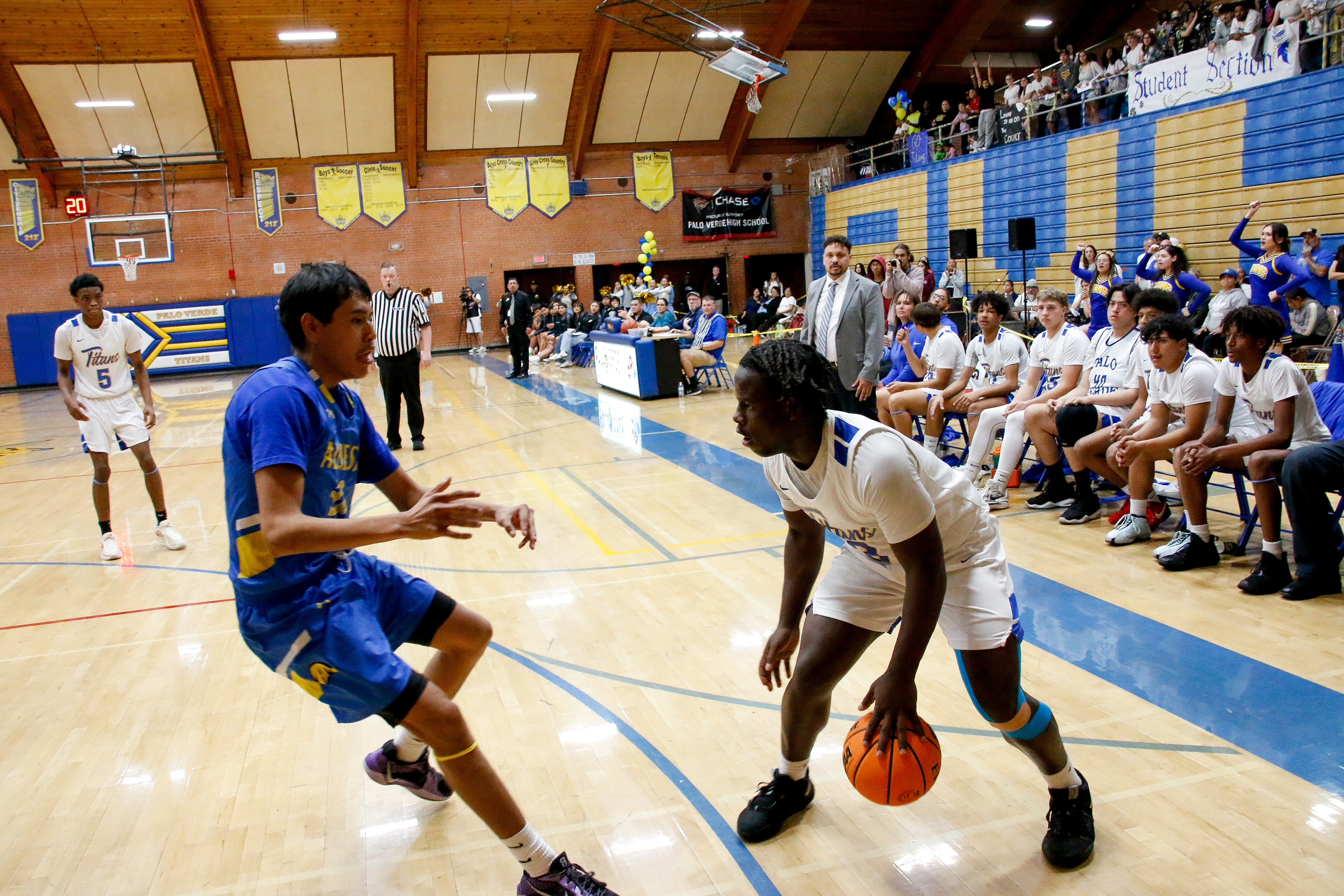 A PV player dribbles the ball to keep it away from his opponent