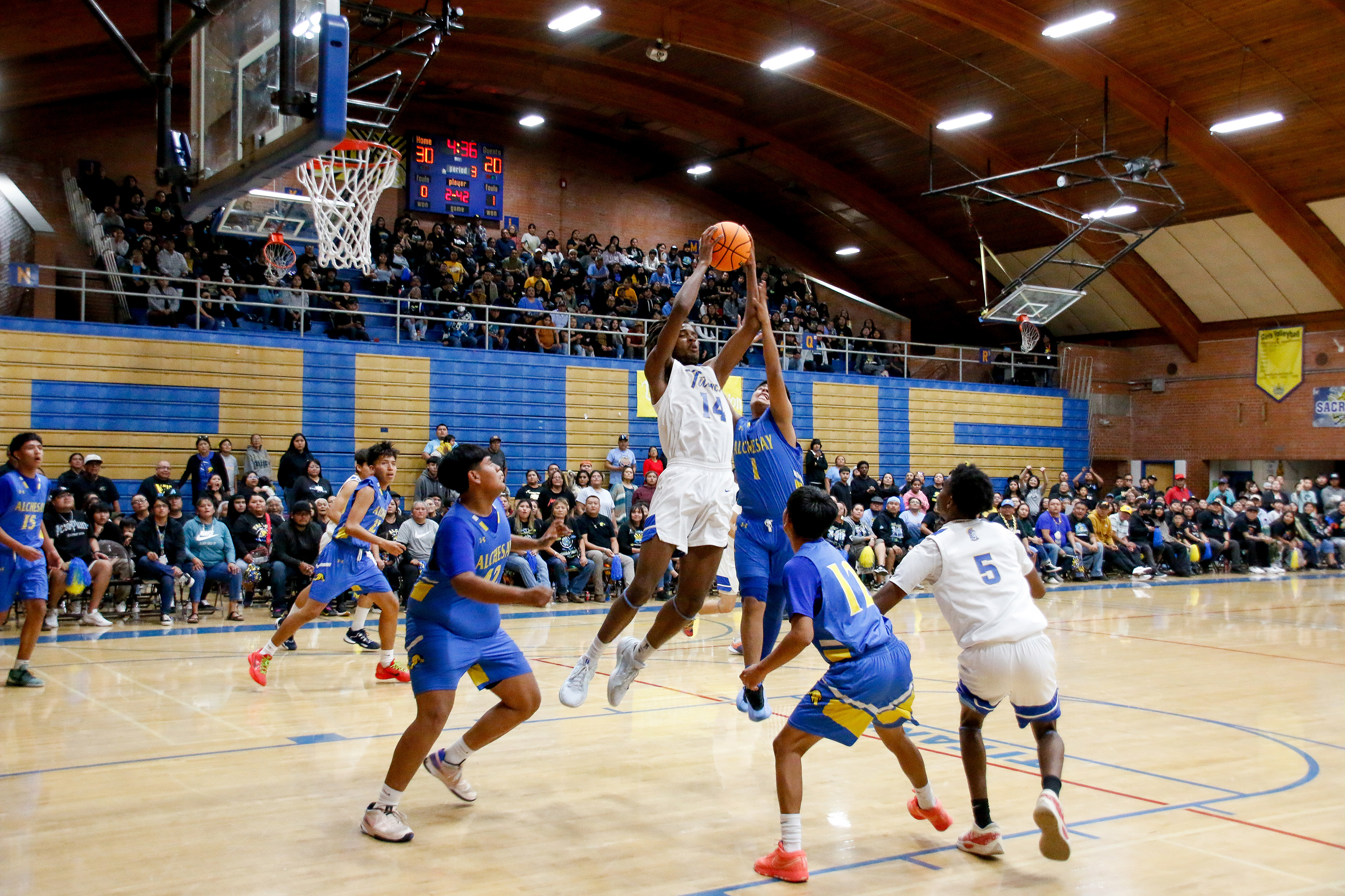 A PV player jumps up to get the basketball and keep it away from the other team