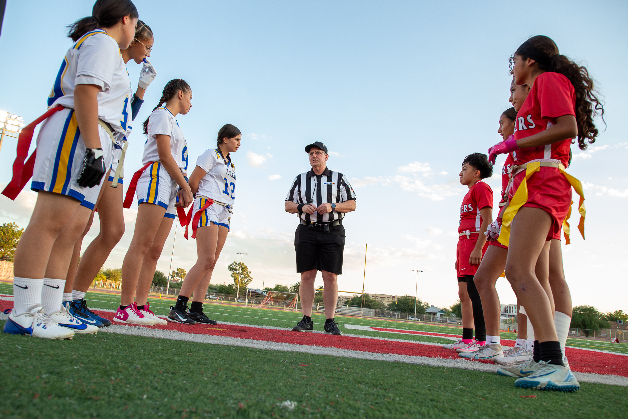 Palo Verde and Tucson High players line up on the field and listen to the referee