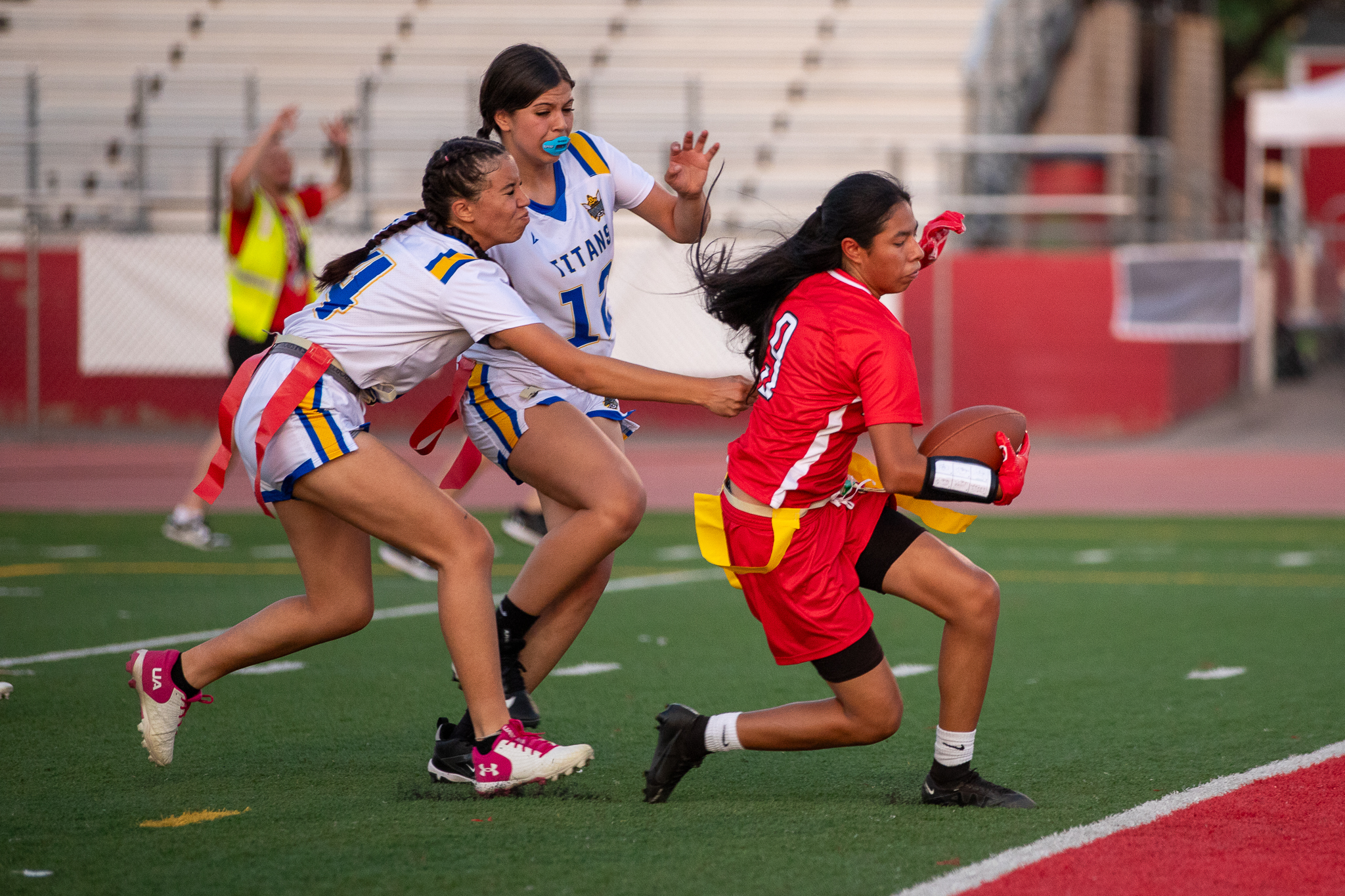 Two Palo Verde players tag a Tucson High player as they run down the field