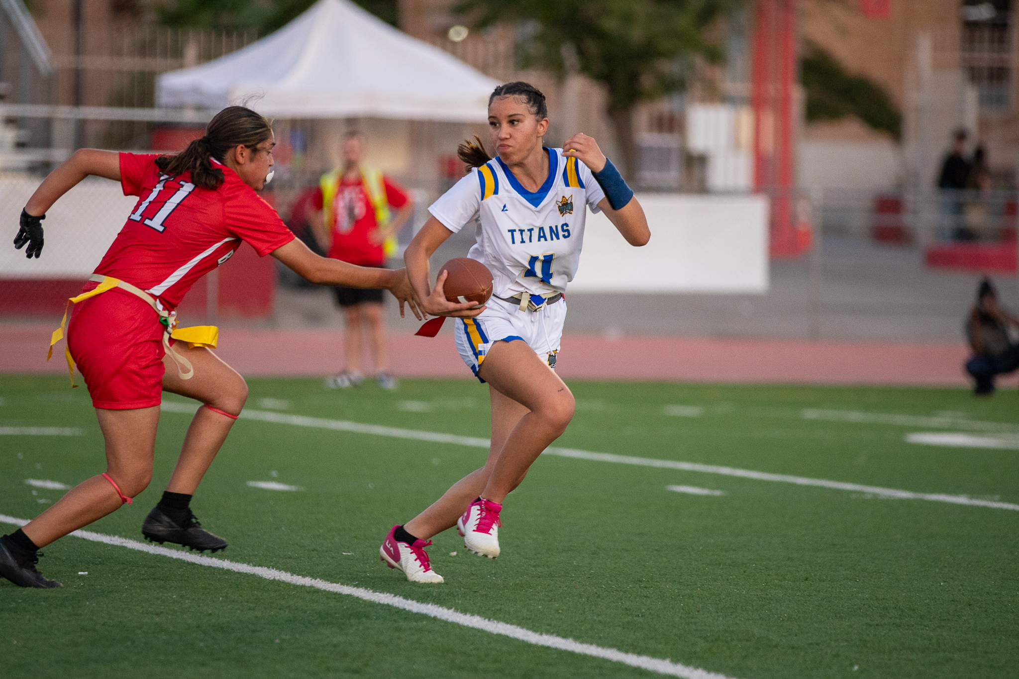 A Palo Verde player runs away from a Tucson High player with the football