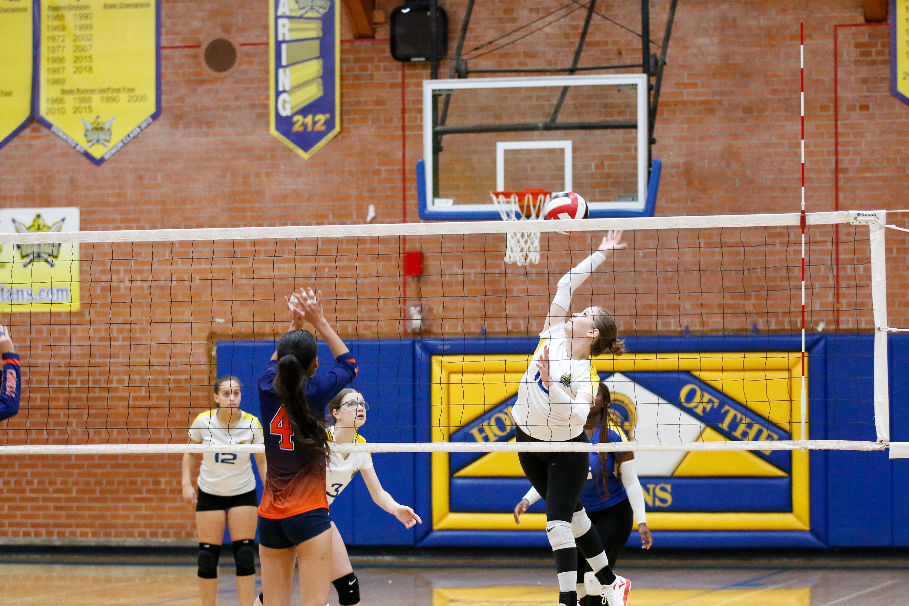 A Palo Verde volleyball player hits the ball over the net