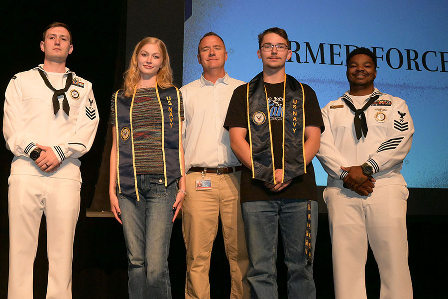 Four students are recognized with military awards from the principal, middle