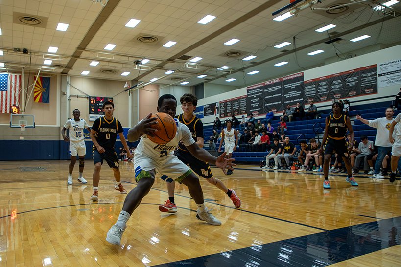 A Palo Verde player guards the ball from his opponents