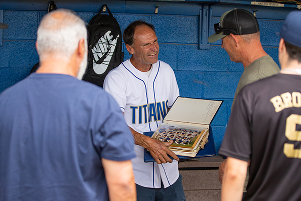 A former baseball coach shows off memories in a photo book