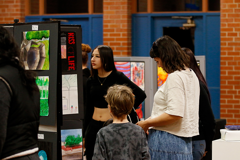 Families peruse the student artwork on display